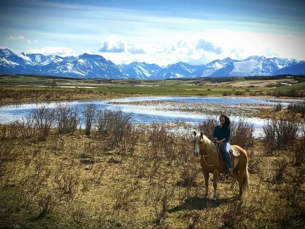Kim on horse with mountain backdrop